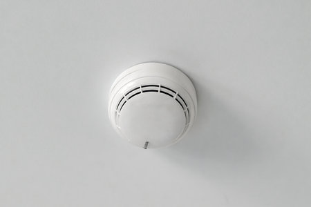 White plastic smoke detector on the ceiling. Fire safety equipment in the house.の写真素材