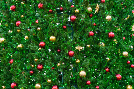 Christmas toys and balls on an artificial spruce. Xmas abstract background.