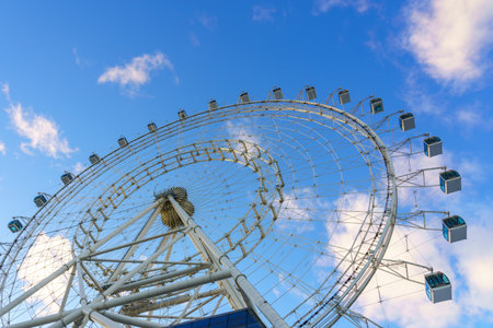 High ferris wheel at sunset or sunrise in an amusement park on a sky background.の写真素材