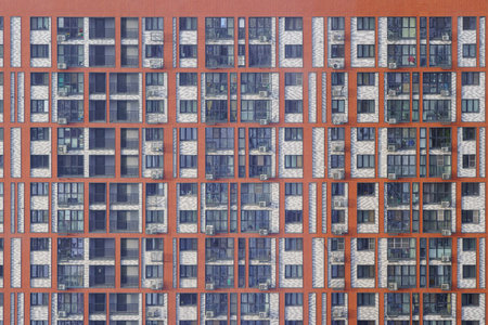 Urban residential complex with vibrant facades in a cityscape, sunny weather, and cloudy sky, concept of modern city architecture.の写真素材