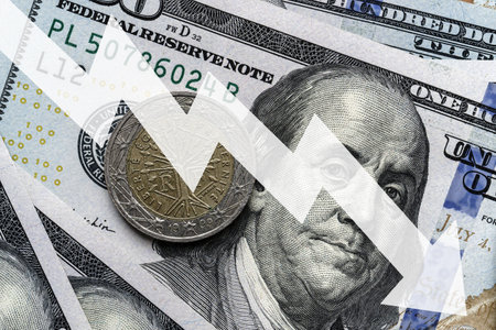 Close-up of a euro coin placed on US 100 dollar bills and arrow down. Concept of currency falling.の写真素材