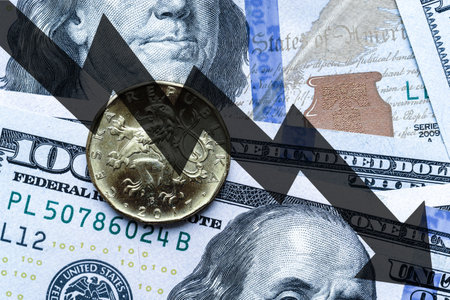 Close-up of a Czech crown coin placed on US 100 dollar bills and arrow down. Concept of currency falling.の写真素材