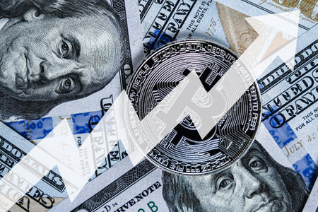 Bitcoin coin on US hundred dollar bills and arrow up. Concept of e-commerce and cryptocurrency value increase in dollars.の写真素材