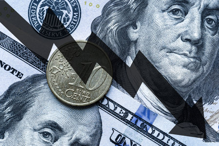 Close-up of a euro coin placed on US 100 dollar bills and arrow down. Concept of currency falling.の写真素材