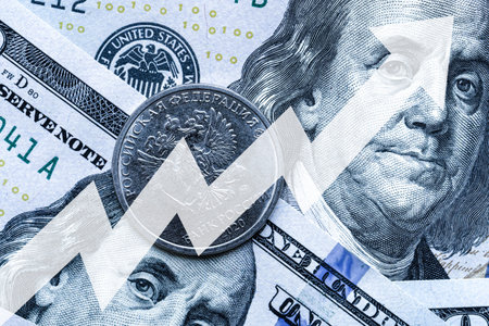 Close-up of a Russian ruble coin placed on US 100 dollar bills and arrow up. Concept of currency increase.の写真素材