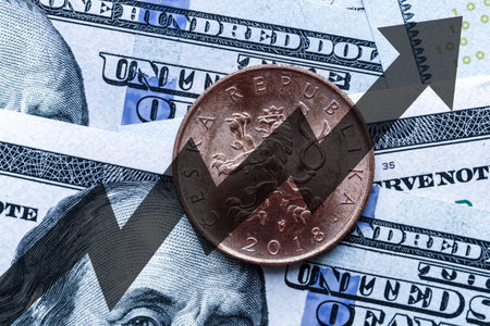 Close-up of a Czech crown coin placed on US 100 dollar bills and arrow up. Concept of currency increase.の写真素材