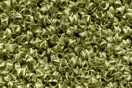 Background of bronze wires twisted into spirals in the form of prisms. Spiral-prismatic nozzle. Abstract metallic background for design.の写真素材