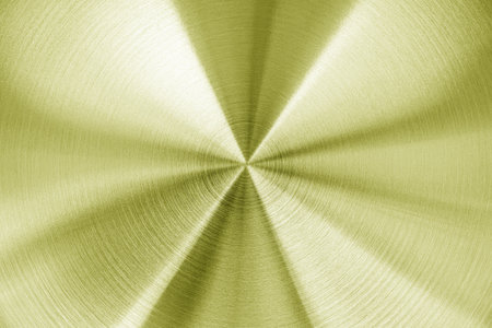 Golden circular brushed shiny metal texture. Abstract metallic background for design. Circle shape.の写真素材