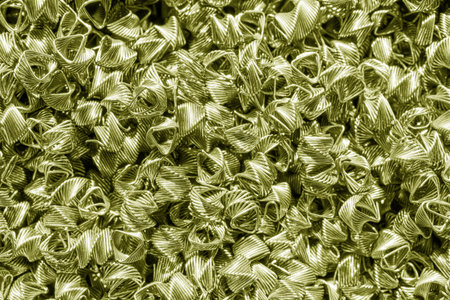 Background of golden wires twisted into spirals in the form of prisms. Spiral-prismatic nozzle. Abstract metallic background for design.の写真素材
