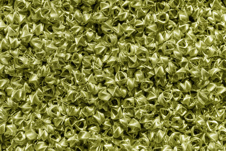 Background of golden wires twisted into spirals in the form of prisms. Spiral-prismatic nozzle. Abstract metallic background for design.の写真素材