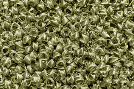Background of bronze wires twisted into spirals in the form of prisms. Spiral-prismatic nozzle. Abstract metallic background for design.の写真素材