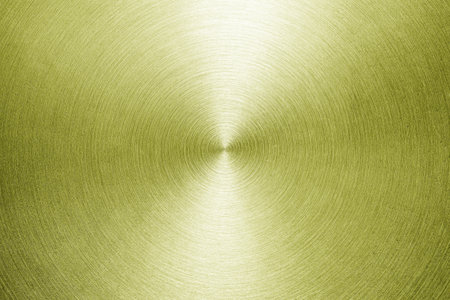Golden circular brushed shiny metal texture. Abstract metallic background for design. Circle shape.の写真素材