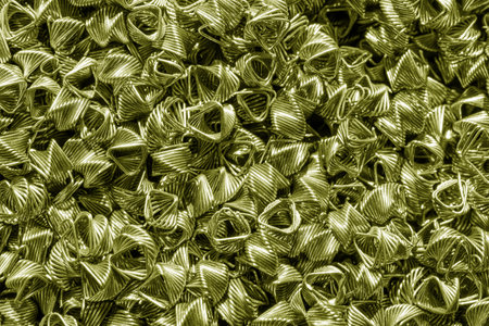 Background of bronze wires twisted into spirals in the form of prisms. Spiral-prismatic nozzle. Abstract metallic background for design.の写真素材