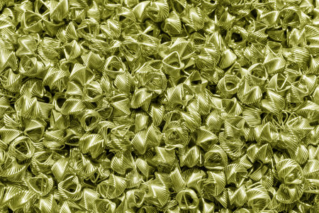 Background of golden wires twisted into spirals in the form of prisms. Spiral-prismatic nozzle. Abstract metallic background for design.の写真素材