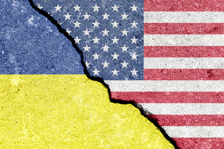 USA and Ukraine flags split on cracked wall for political tension. Countries in conflict, economic sanctions and international relations as a concept for global politics situation.の写真素材