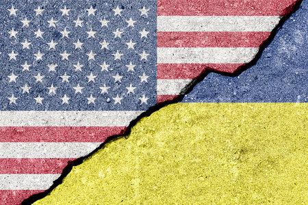 USA and Ukraine flags split on cracked wall for political tension. Countries in conflict, economic sanctions and international relations as a concept for global politics situation.の写真素材