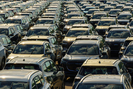 Russia, Kaluga, AGR Automotive Group - July 7, 2025: Rows of new cars parked close together in a large open-air lot, representing automotive industry production and transportationのeditorial素材