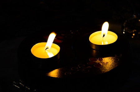 The warmth of candle light the dark night.の写真素材