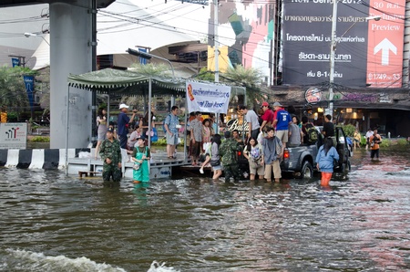 BANGKOK THAILAND  NOVEMBER 13: Truck carries a group of people to evacuate from the flooded area at Phahon Yothin Road during the massive flood crisis on November 13, 2011 in Bangkok, Thailand.のeditorial素材