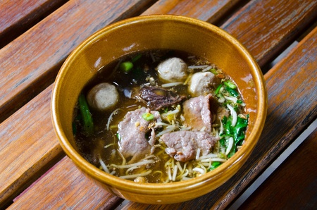 Asian soup with noodles and meat ball.