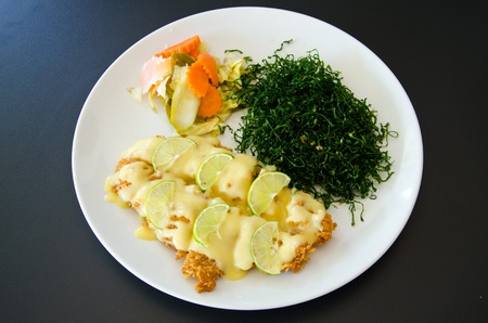 Fried fish topped with lemon sauce.