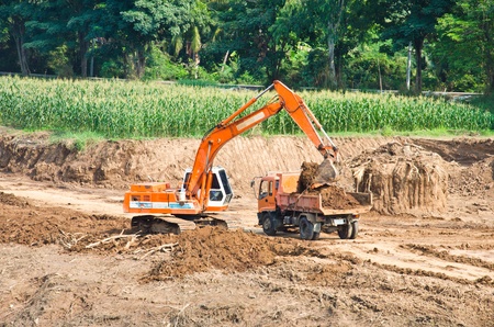 Heavy excavator loader at soil moving works at construction site