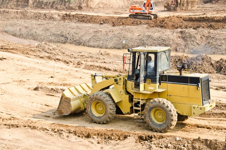 Heavy excavator loader at soil moving works at construction site