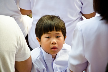 BANGKOK , THAILAND - MARCH 24: Unidentified Boy  gives food offerings to a Buddhist monk on March 24, 2012 Chinatown in Bangkok, Thailand. Thai traditional, people will make merit making by give food to monk. The occasion BuddhaJayanti 2600 years.のeditorial素材