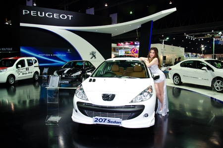 BANGKOK - MARCH 27: Peugeot 207 Sedan car with unidentified model on display at The 33th Bangkok International Motor Show  on March 27, 2012 in Bangkok, Thailand.のeditorial素材