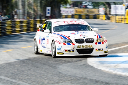 CHON BURI - DECEMBER 22: Tin S. with BMW E90  car on display at the Bangsaen Thailand Speed Festival 2013 Race 8 on December 22, 2013 at the Bangsaen street circuit , Thailand.のeditorial素材