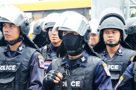 BANGKOK - MAY 24  Riot police stand guard on Major Cineplex Ratchayothin Bangkok during a violent anti-Military coup on May 24, 2014 in Bangkok, Thailand のeditorial素材