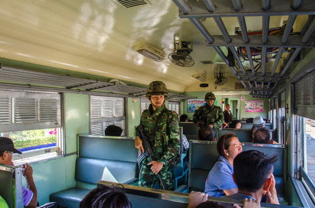 AYUTTHAYA - MAY 24  Soldier search weapons or person on trains traveling to Bangkok after military coup on May 24, 2014 in Ayutthaya, Thailand のeditorial素材