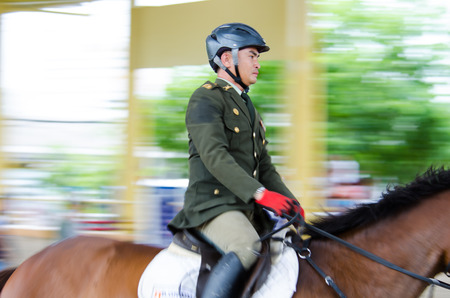 BANGKOK, THAILAND - JUNE 22: Unidentified Equestrian with horse at MaxWin Show Jumping League & Horse Guard 2014  on June 22, 2014 in Royal Horse Guard MaxWin Riding Arena Bangkok, Thailand.のeditorial素材