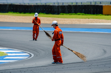 BURIRAM - JUNE 20: Marshal was sweeping the road to prepare for The 2015 Autobacs Super GT Series Race 3 on June 20, 2015 at Chang International Racing Circuit, Buriram Thailand.のeditorial素材