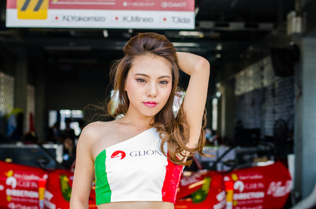BURIRAM - JUNE 21: Unidentified Race Queen of Japan with racing car on display at The 2015 Autobacs Super GT Series Race 3 on June 21, 2015 at Chang International Racing Circuit, Buriram Thailandのeditorial素材