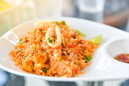 Fried rice with squid and lemon grass soup with mushrooms, Thai food.の写真素材