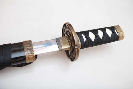 Japanese samurai sword on a white background. Weapons used in warfare in ancient times.
