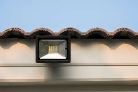 LED flood light, spot light on the roof with blue sky backgroundの写真素材