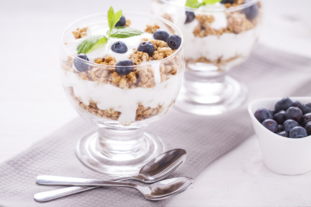 Fruity dessert with cereals on a wooden boardの写真素材