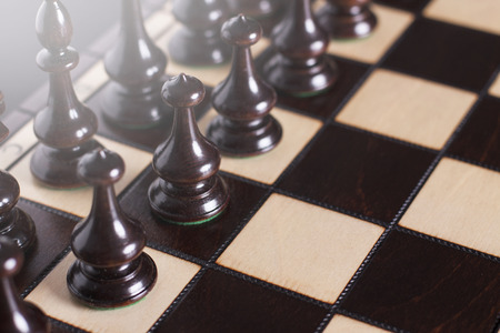 Chess pawns on the chessboard. Closeup