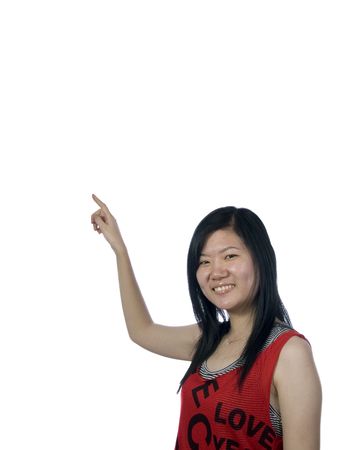 Young girl pointing upwards on white backgroundの写真素材