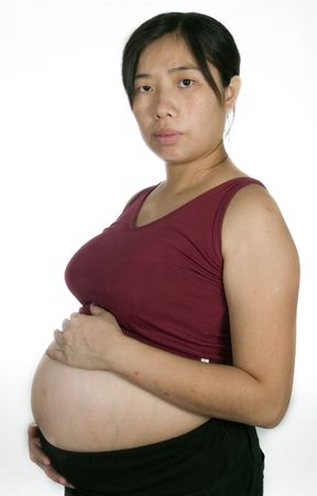 A pregnant women show her tummy with white backgroundの写真素材