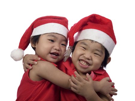 two little girls who celebrate christmas day with white backgroundの写真素材