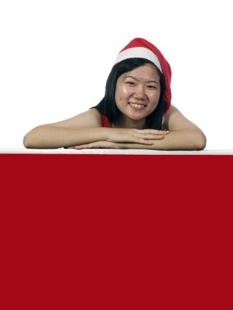 Christmas santa girl holding a notice board with white backgroundの写真素材