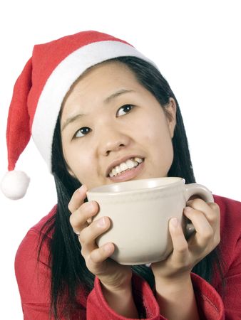 Beautiful girl in christmas clothes with cup of coffee or drinkの写真素材