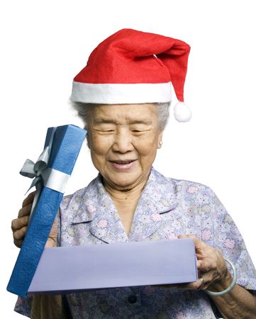 Grandmother in christmas clothes with a gift.の写真素材