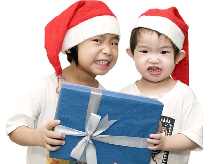 two little girls who celebrate christmas day with white backgroundの写真素材