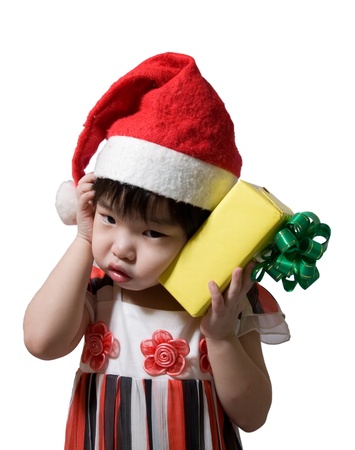 portrait of a little girl with santa hat and gift.の写真素材