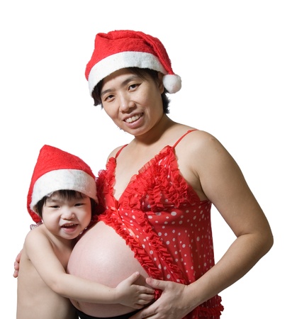 christmas pregnant woman and little girl with white background.の写真素材