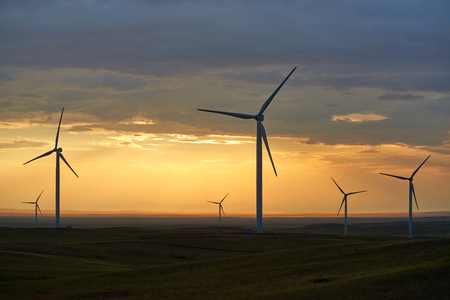 Wind power stations. Wind power wind turbines to mechanically power generators for electric power. A wind farm is a group of wind turbines in the same location.の写真素材